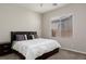 Cozy bedroom featuring a large bed and natural light from the window at 3084 Porte La Paz Ave, Henderson, NV 89044