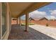 This covered patio has a paver floor and leads to the backyard with artificial turf at 3084 Porte La Paz Ave, Henderson, NV 89044