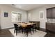 Dining room featuring a wooden table, black chairs, and stylish decor at 3084 Porte La Paz Ave, Henderson, NV 89044