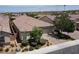 This home has a red tile roof, desert landscaping, and a two car garage at 3084 Porte La Paz Ave, Henderson, NV 89044