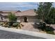 This home has a red tile roof, desert landscaping, and a three car garage at 3084 Porte La Paz Ave, Henderson, NV 89044