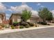 Charming single story stucco home with desert landscaping, an arched entryway and a two-car garage at 3084 Porte La Paz Ave, Henderson, NV 89044