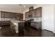 Spacious kitchen with dark wood cabinets, stainless appliances, granite counters, and dark wood floors at 3084 Porte La Paz Ave, Henderson, NV 89044