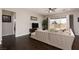 Bright living room with a large couch, sliding glass doors to the backyard and sleek dark hardwood floors at 3084 Porte La Paz Ave, Henderson, NV 89044