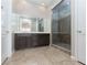 Bathroom featuring a double vanity and a glass-enclosed shower at 3084 Porte La Paz Ave, Henderson, NV 89044