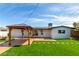 Expansive backyard with lush lawn, covered patio, and sliding glass doors for seamless indoor-outdoor living at 3308 Navajo Way, Las Vegas, NV 89108