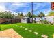 Grassy backyard with a storage shed and stepping stones, perfect for outdoor activities and storage at 3308 Navajo Way, Las Vegas, NV 89108