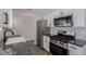 Bright kitchen features stainless appliances, granite counters, undermount sink and custom backsplash at 3308 Navajo Way, Las Vegas, NV 89108