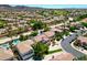 This aerial shot showcases a house with pool in a golf course community surrounded by desert landscaping and mountains at 335 Pleasant Summit Dr, Henderson, NV 89012