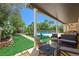 Outdoor living space with artificial turf, a covered patio, an outdoor kitchen, and a gated pool at 335 Pleasant Summit Dr, Henderson, NV 89012