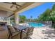 Inviting outdoor patio space with comfortable seating, a dining table, and a beautiful view of the sparkling pool at 335 Pleasant Summit Dr, Henderson, NV 89012