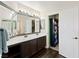 Bathroom with double sinks, vanity and dark wood floors, as well as white cabinets at 335 Pleasant Summit Dr, Henderson, NV 89012