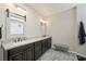 Bathroom featuring a long vanity with double sinks and dark brown cabinets at 335 Pleasant Summit Dr, Henderson, NV 89012