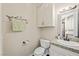 Neat half bathroom with granite countertop and wood cabinets providing a convenient and stylish space for guests at 335 Pleasant Summit Dr, Henderson, NV 89012