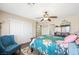 Bedroom showcasing ceiling fan, closet, and bed with blue floral comforter at 335 Pleasant Summit Dr, Henderson, NV 89012