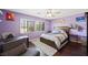 Bright purple bedroom featuring a ceiling fan, a desk, and modern decor at 335 Pleasant Summit Dr, Henderson, NV 89012