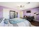 Inviting bedroom features a ceiling fan, desk, and a bookcase filled with an assortment of items at 335 Pleasant Summit Dr, Henderson, NV 89012