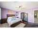 Purple bedroom featuring a ceiling fan, bed with gray comforter, and dark wood floors at 335 Pleasant Summit Dr, Henderson, NV 89012