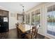 Dining area with hardwood floors, shutters on windows, view of pool and modern chandelier at 335 Pleasant Summit Dr, Henderson, NV 89012