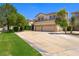 Spacious two-story home with a three-car garage and ample driveway space, surrounded by mature landscaping at 335 Pleasant Summit Dr, Henderson, NV 89012
