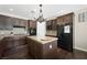 Well-lit kitchen with dark wood cabinets, stainless steel appliances, and granite countertops at 335 Pleasant Summit Dr, Henderson, NV 89012