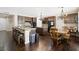 Open kitchen with hardwood floors, stainless steel appliances, island and breakfast table at 335 Pleasant Summit Dr, Henderson, NV 89012