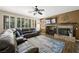 Comfortable living room featuring a fireplace, ceiling fan and plantation shutters at 335 Pleasant Summit Dr, Henderson, NV 89012