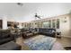 Open-concept living room with fireplace, large sectional sofa, ceiling fan, and wood floors at 335 Pleasant Summit Dr, Henderson, NV 89012