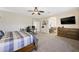 Open main bedroom with carpet, ceiling fan, and entry to main bathroom at 335 Pleasant Summit Dr, Henderson, NV 89012