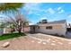 Exterior view of backyard featuring an artificial lawn, rock landscaping, and covered patio at 3572 Tempe St, Las Vegas, NV 89103
