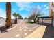 Backyard view featuring a covered patio, mature trees, and rock landscaping, and an artificial lawn at 3572 Tempe St, Las Vegas, NV 89103