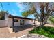 Backyard featuring a large, mature tree, an artificial lawn, and a covered patio at 3572 Tempe St, Las Vegas, NV 89103