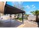 Backyard with a covered patio, rock landscaping, palm trees and a mature tree at 3572 Tempe St, Las Vegas, NV 89103