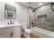 Bright bathroom featuring a modern vanity, sleek fixtures, and shower over tub with decorative tiling at 3572 Tempe St, Las Vegas, NV 89103