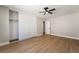 Bedroom featuring a closet with sliding doors, wood floors and a ceiling fan at 3572 Tempe St, Las Vegas, NV 89103