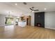 Open-concept area with island kitchen, stainless steel appliances, and modern fireplace at 3572 Tempe St, Las Vegas, NV 89103