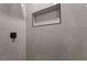 Close up of updated shower featuring light-colored tile and black shower trim at 3572 Tempe St, Las Vegas, NV 89103