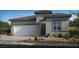Contemporary home featuring a two-car garage and desert landscaping at 4130 E Brusca Way, Pahrump, NV 89061