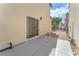 A view of backyard with a patio, sliding glass door, and gate access to the street at 4252 Olympic Point Dr, Las Vegas, NV 89129