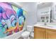 Bright bathroom with a tub-shower combination, toilet, and wooden vanity with sink at 4252 Olympic Point Dr, Las Vegas, NV 89129