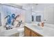 Bathroom featuring a turtle themed shower curtain, single sink vanity, and tiled floors at 4252 Olympic Point Dr, Las Vegas, NV 89129