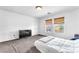 Bright, carpeted bedroom with white walls ready for your personal touch, with dual windows and television at 4252 Olympic Point Dr, Las Vegas, NV 89129