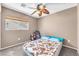Cozy bedroom with a ceiling fan and a window that provides natural light at 4252 Olympic Point Dr, Las Vegas, NV 89129