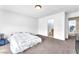 Bright, carpeted bedroom with white walls ready for your personal touch, with adjacent bathroom access at 4252 Olympic Point Dr, Las Vegas, NV 89129