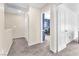 Hallway with multiple closets leading to a bedroom or office with blue accent wall at 4252 Olympic Point Dr, Las Vegas, NV 89129
