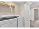 Practical laundry room with washer, dryer, and storage shelves for convenience at 4252 Olympic Point Dr, Las Vegas, NV 89129