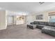 Spacious living room with plush carpeting, a large sectional sofa, and plenty of natural light at 4252 Olympic Point Dr, Las Vegas, NV 89129