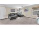 Inviting living room showcasing a comfortable sofa, natural lighting, and neutral-toned walls and carpeting at 4252 Olympic Point Dr, Las Vegas, NV 89129