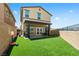 Backyard featuring a patio, artificial grass, and privacy fence at 440 Blue Lark Dr, Henderson, NV 89011