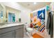Bright bathroom featuring patterned shower curtain, single sink, and ample lighting at 440 Blue Lark Dr, Henderson, NV 89011